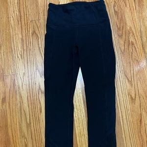 lululemon size 4 black ankle length leggings, see-through mesh down sides.